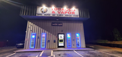 AB Tobacco & Vapor storefront lit by red and blue neon signage at night in Piedmont, South Carolina